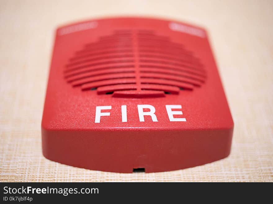 Square red fire alarm on the wall