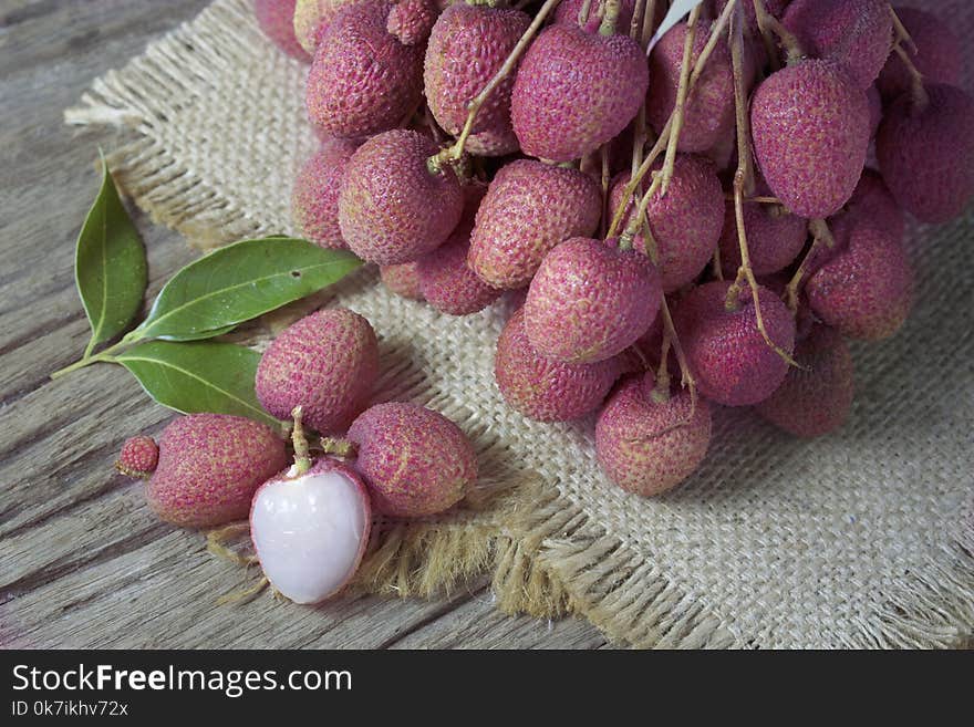 Litchi, lichee, lychee, or lichi, Litchi on sackcloth on old wooden background