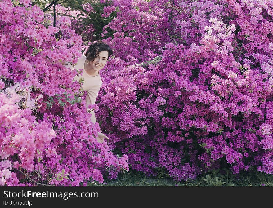 Beautiful girl and flowering rhododendron