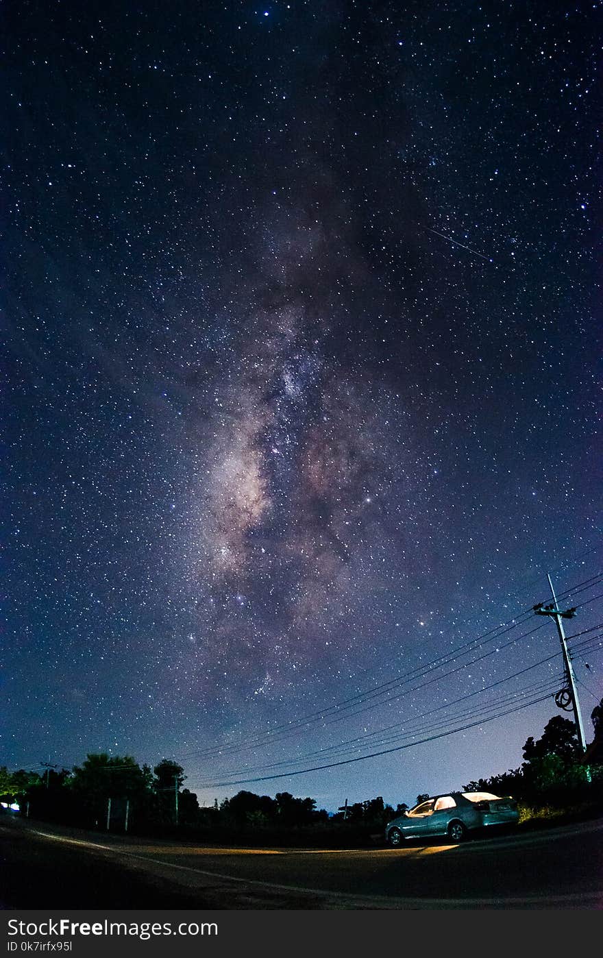 The Milky Way with the tree and car in foreground