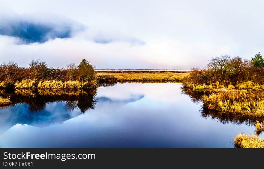 Fog hanging over the Pitt River and the waters of Pitt-Addington Marsh in Pitt Polder near Maple Ridge in British Columbia, Canada