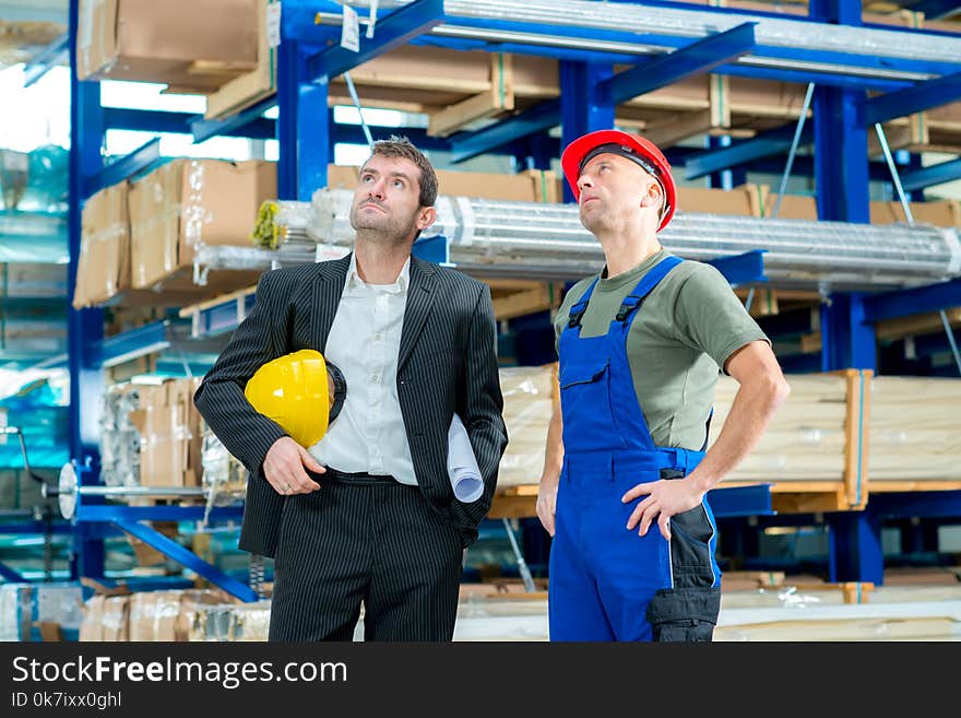 In the factory- young boss and worker in conversation