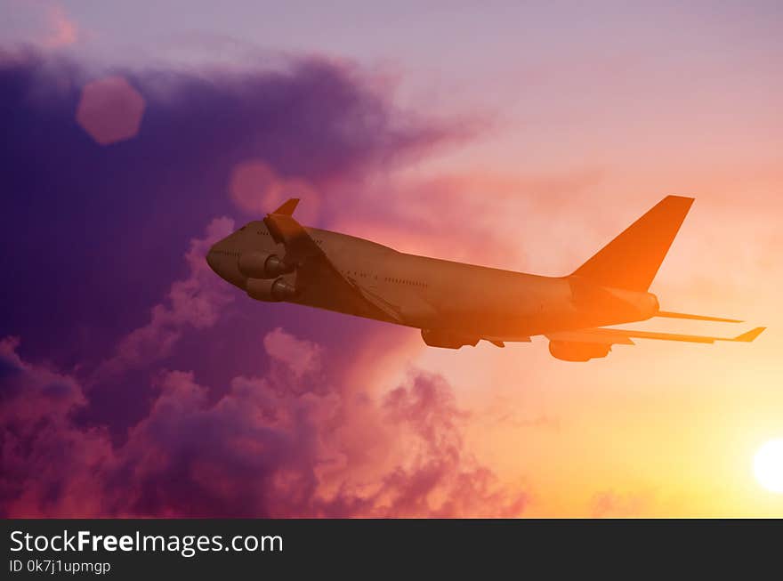 Silhouette of a plane flying in Beautiful sunset. Silhouette of a plane flying in Beautiful sunset.