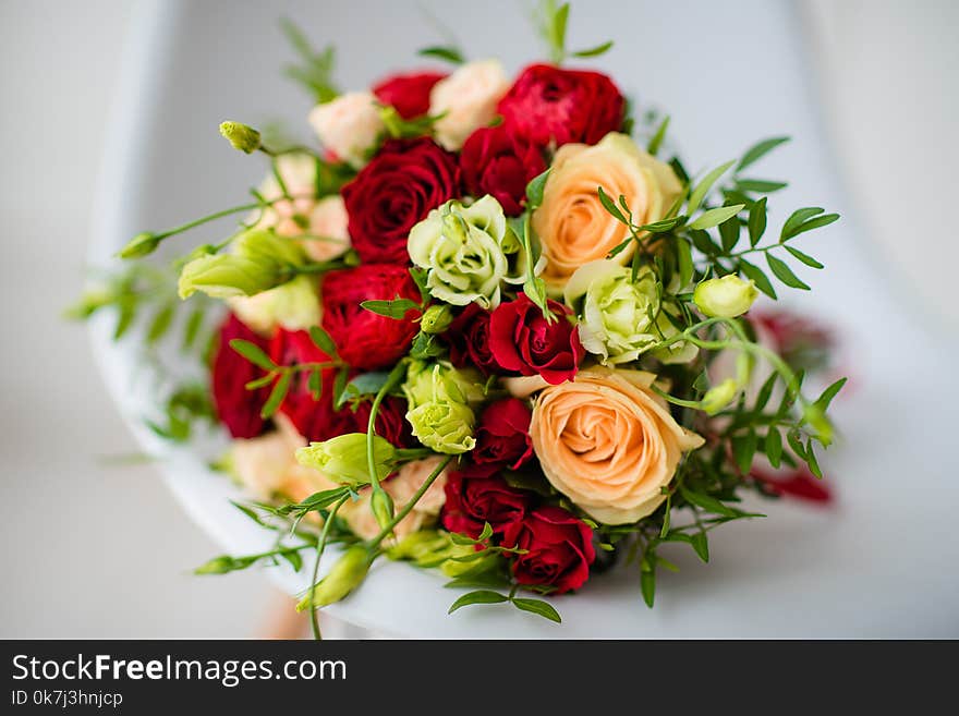 Bridal bouquet of red roses, with red satin ribbons