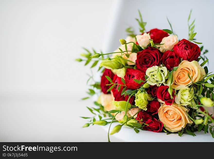 Bridal bouquet of red roses, with red satin ribbons