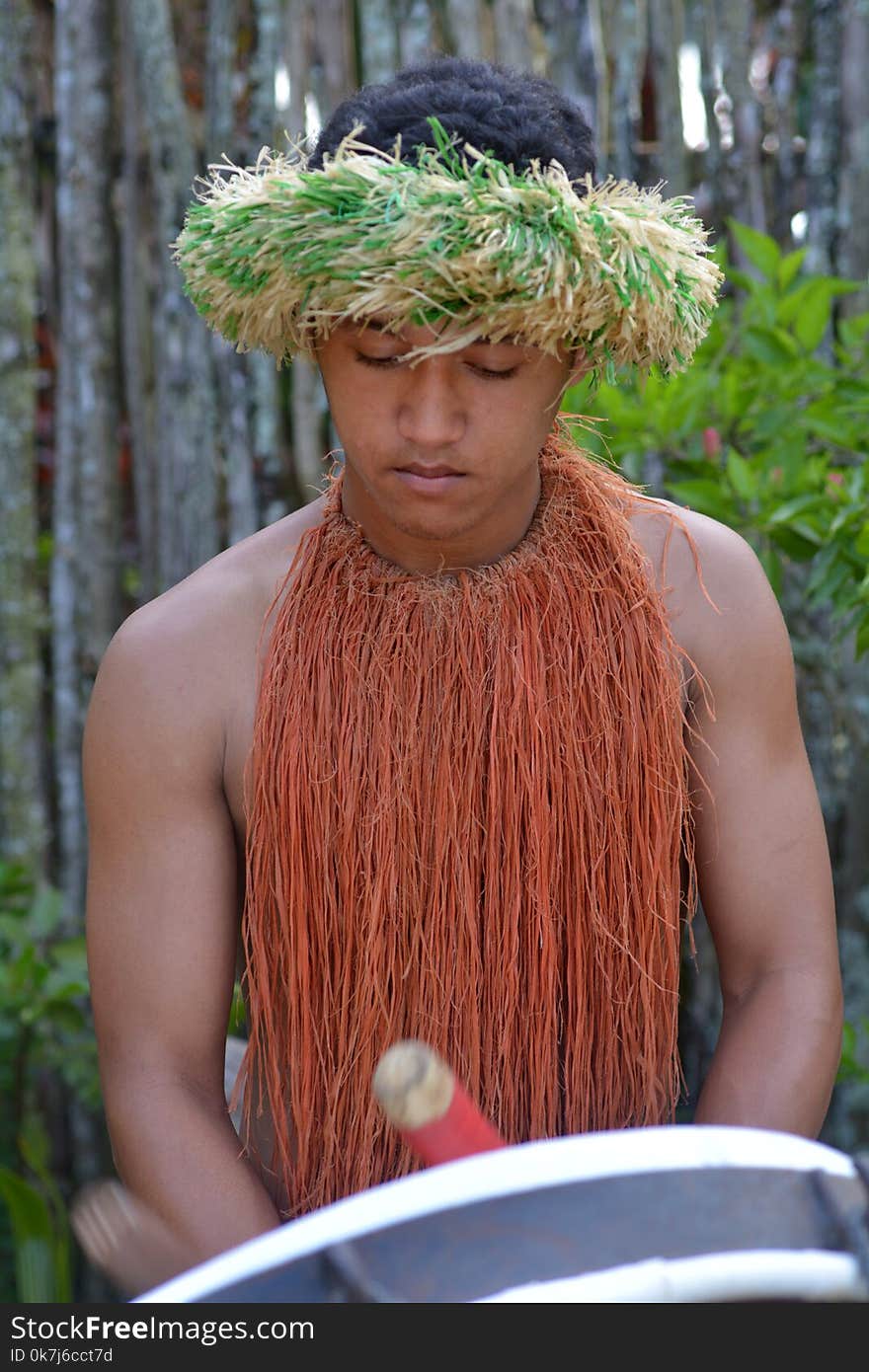 Cook Islander man plays music on a large drum instrument in Rarotonga, Cook Islands. Real people. Copy space. Cook Islander man plays music on a large drum instrument in Rarotonga, Cook Islands. Real people. Copy space