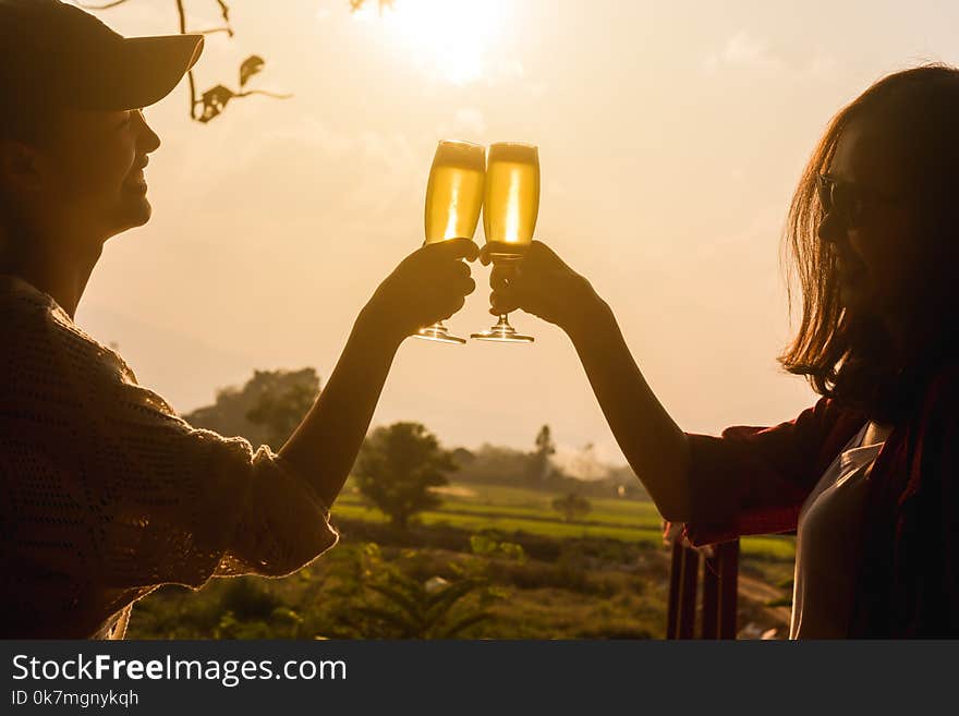 Hands of two women toast champange celebrating under afternoon s