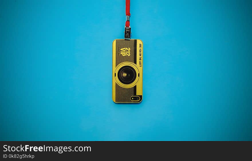 Yellow 212 Vip Camera Hanging on Blue Wall