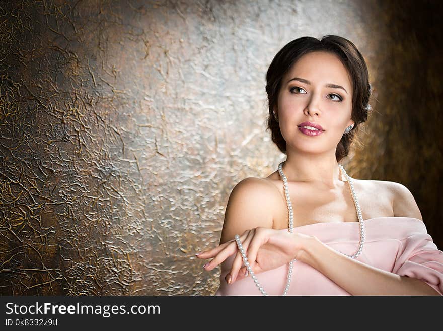 Young elegant woman in evening gold dress