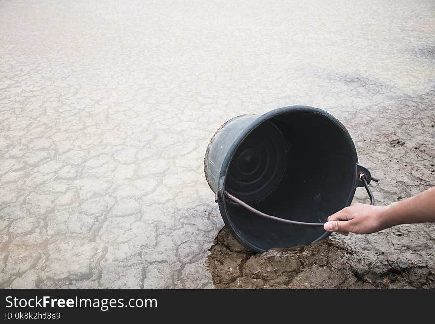 Woman hand are scooping water on cracked ground, Crisis of water shortage. Woman hand are scooping water on cracked ground, Crisis of water shortage.