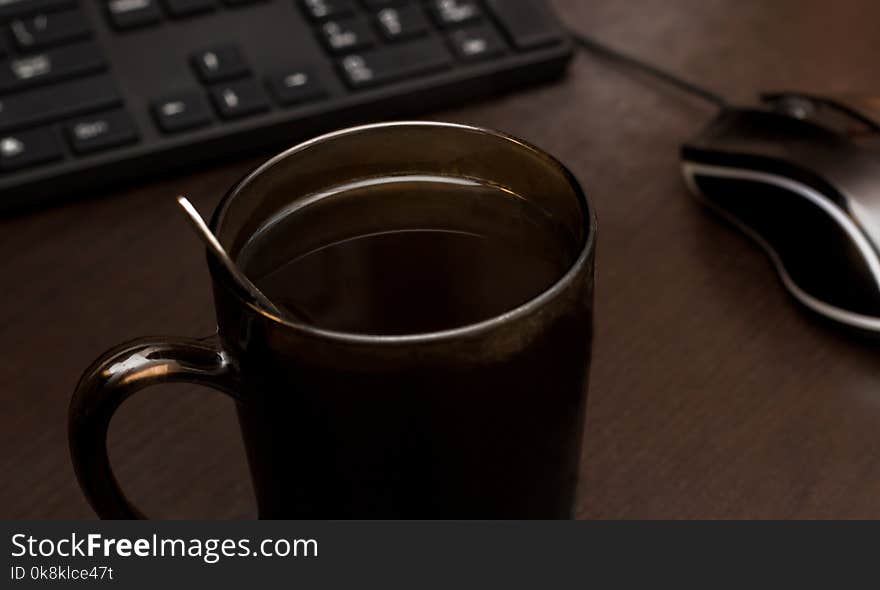 A cup of coffee, a mouse and a keyboard, the morning