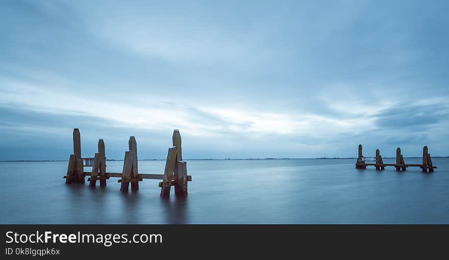 Long Exposure Of River With Bollards