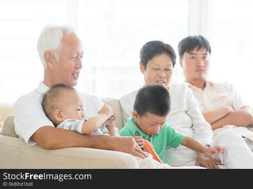 Candid of Asian family at home, multi generations people indoor lifestyle.