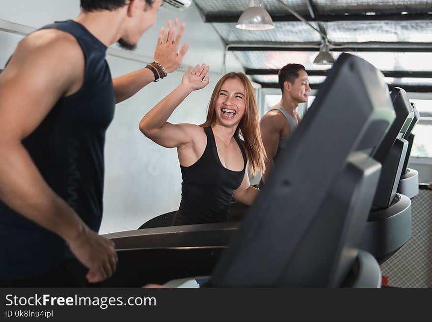 Asian young beautiful women exercising on treadmill with friend in fitness gym. Asian young beautiful women exercising on treadmill with friend in fitness gym