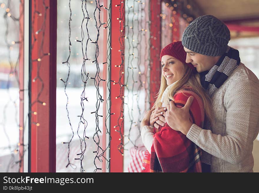 Young Couple In Love At The Window