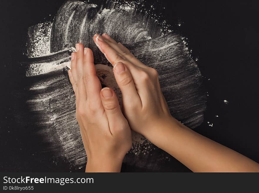 Female Hand With Flour On A Black Background. Cooking