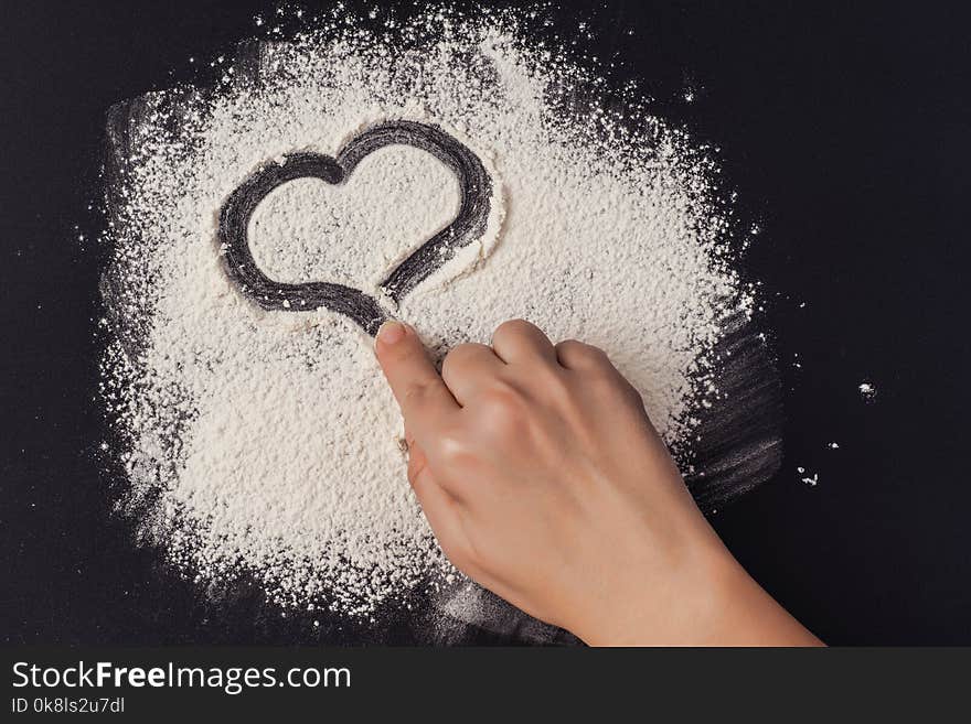 Heart shape on the background of flour. Concept