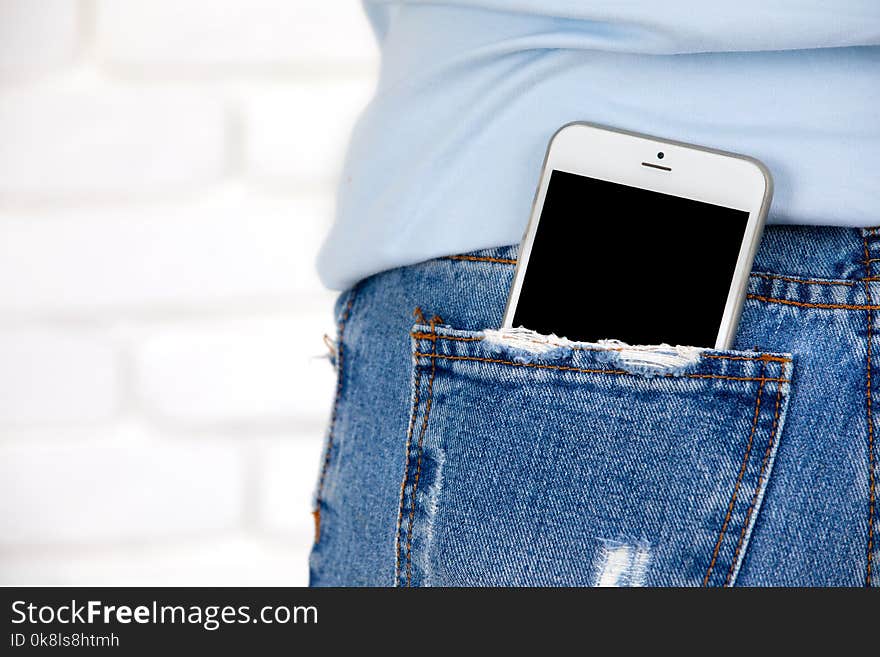 Smartphone with blank screen in jeans pocket.