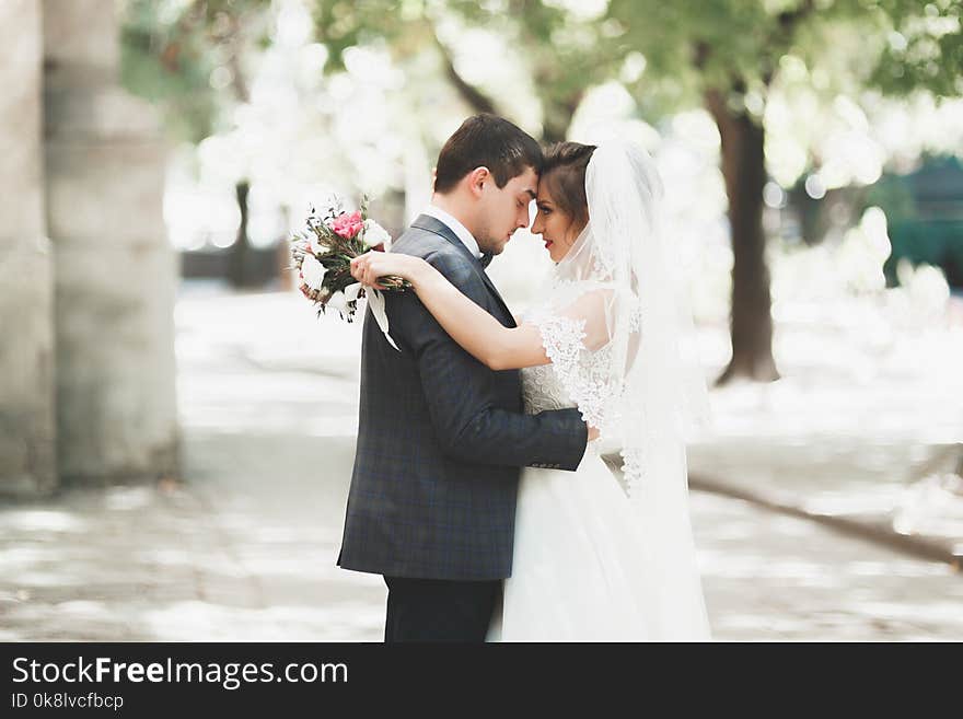 Gorgeous wedding couple walking in the old city of Lviv