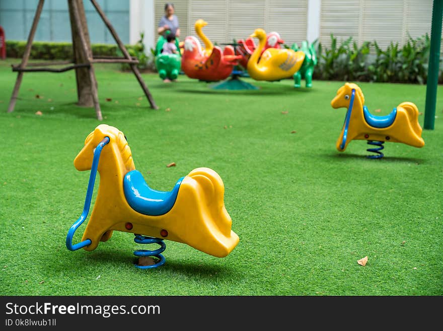 Rocking horse on children playground in the city