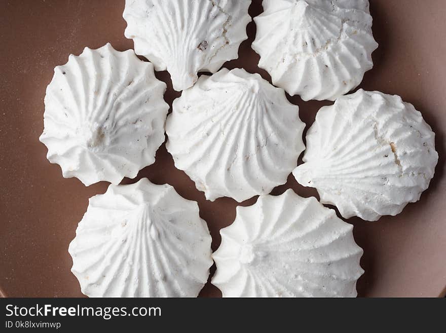 Sweet dessert white zephyr marshmallows on clay plate and rustic wooden background. Sweet dessert white zephyr marshmallows on clay plate and rustic wooden background