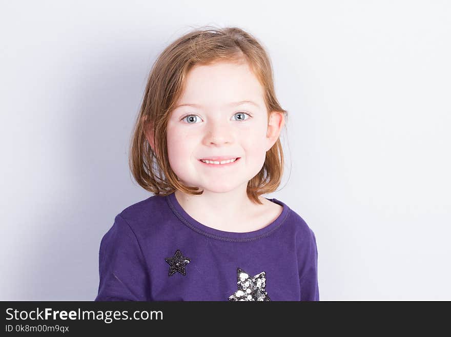 portrait of Girl Sitting under wall Isolated in grey White