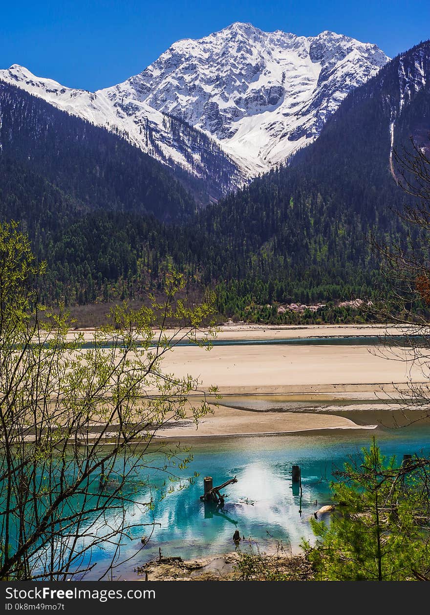 Snow mountain , clear green river landscape of valley