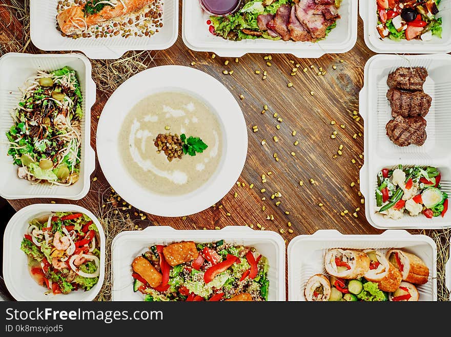 Healthy food delivery. Take away for diet. Fitness nutrition, vegetables, meat and fruits in white eco boxes. Top view, flat lay at natural wood with copy space