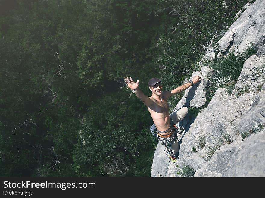 Man rock climber climbs on the cliff. the climber climbs to the top of the mountain.