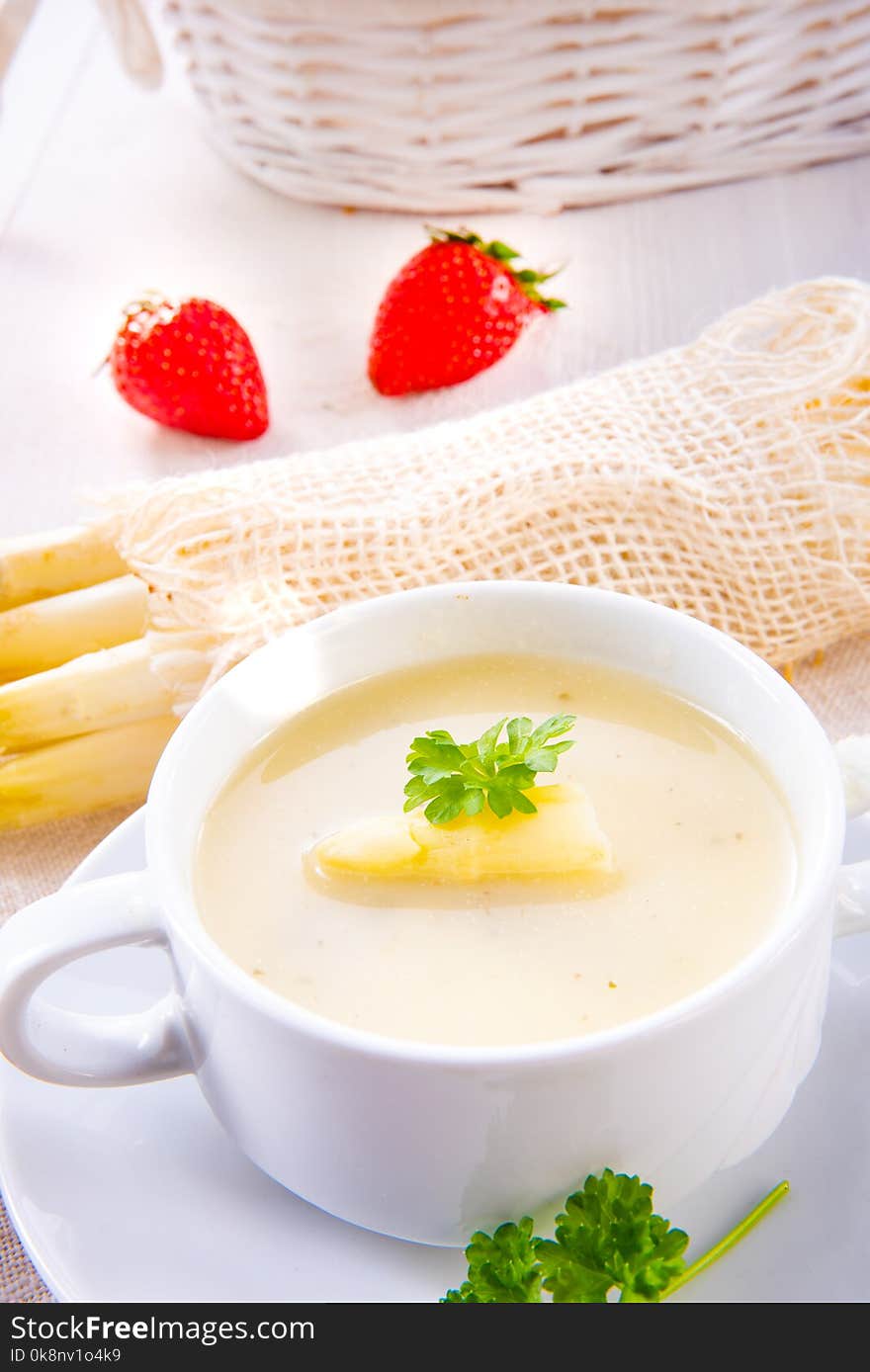 Asparagus cream soup with capers and fresh baguette