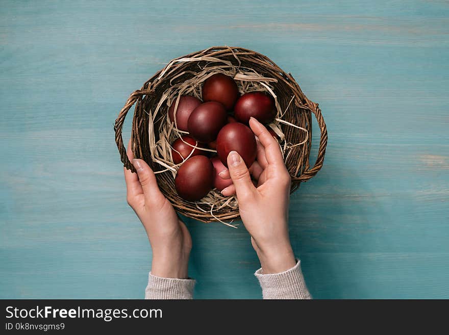 Woman putting easter eggs in basket