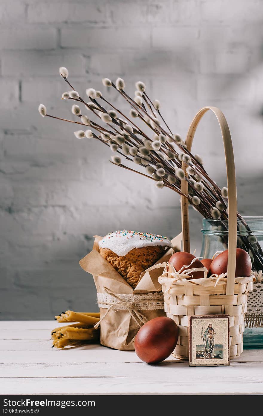 Easter bread, orthodox icon and painted eggs on wooden table