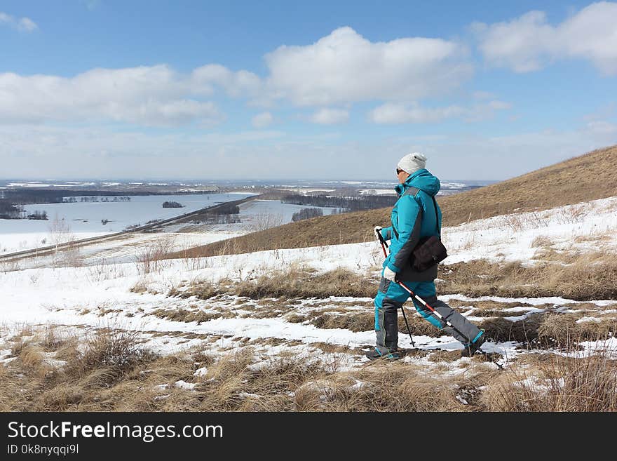 Nordic Walking - adult woman descending from the mountain, Bugotaksky hills, Novosibirsk region, Russia