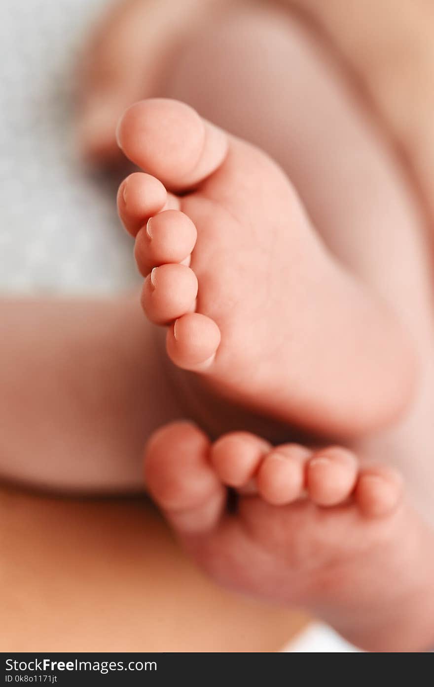 Close-up of child`s legs in background with mother