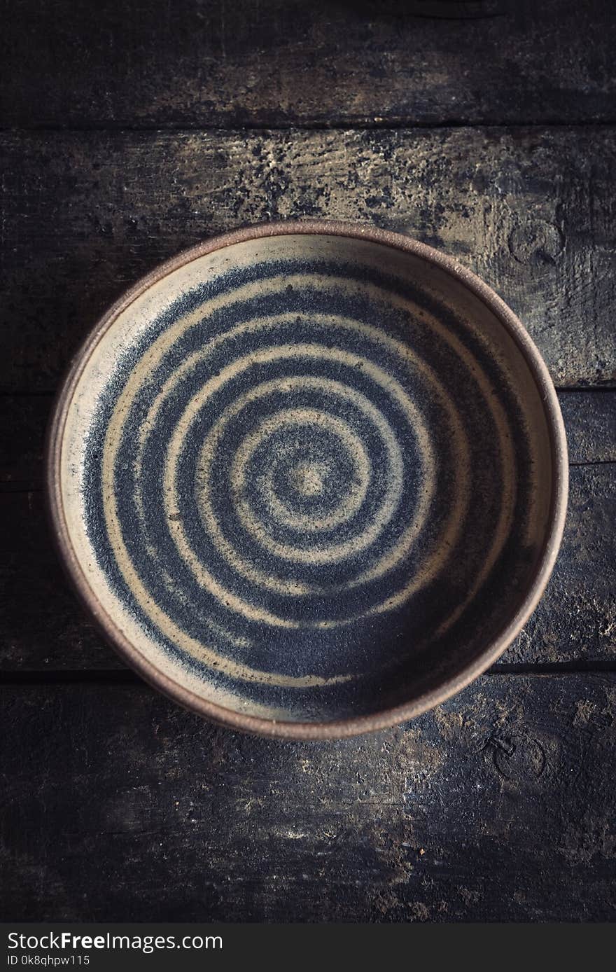 Empty ceramic plate on the wooden background. Empty ceramic plate on the wooden background