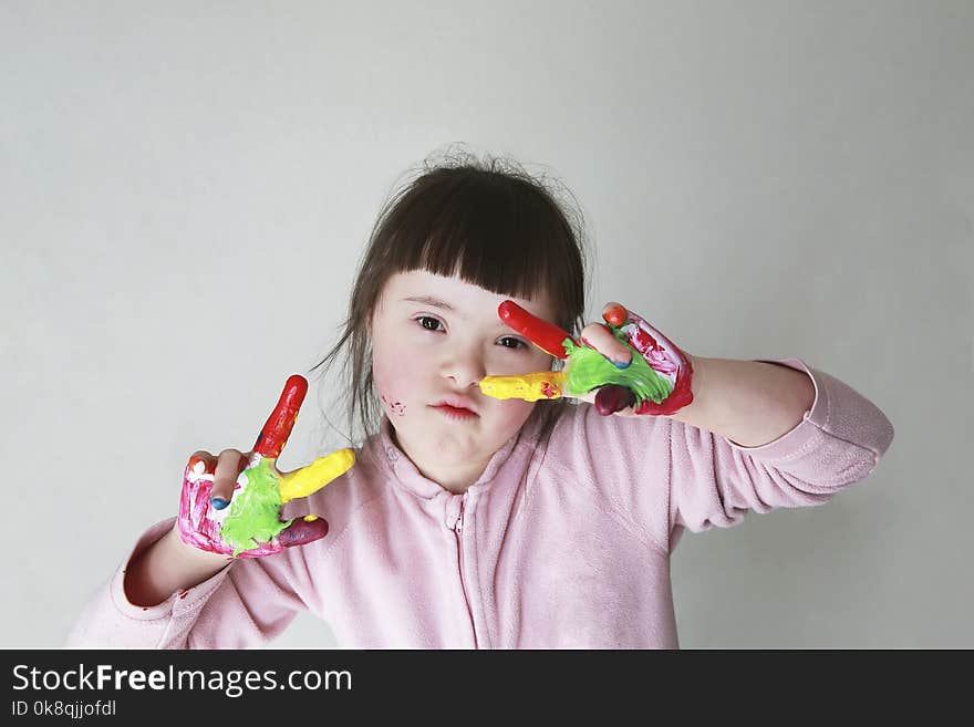 Cute little girl with painted hands. on grey background. Cute little girl with painted hands. on grey background.