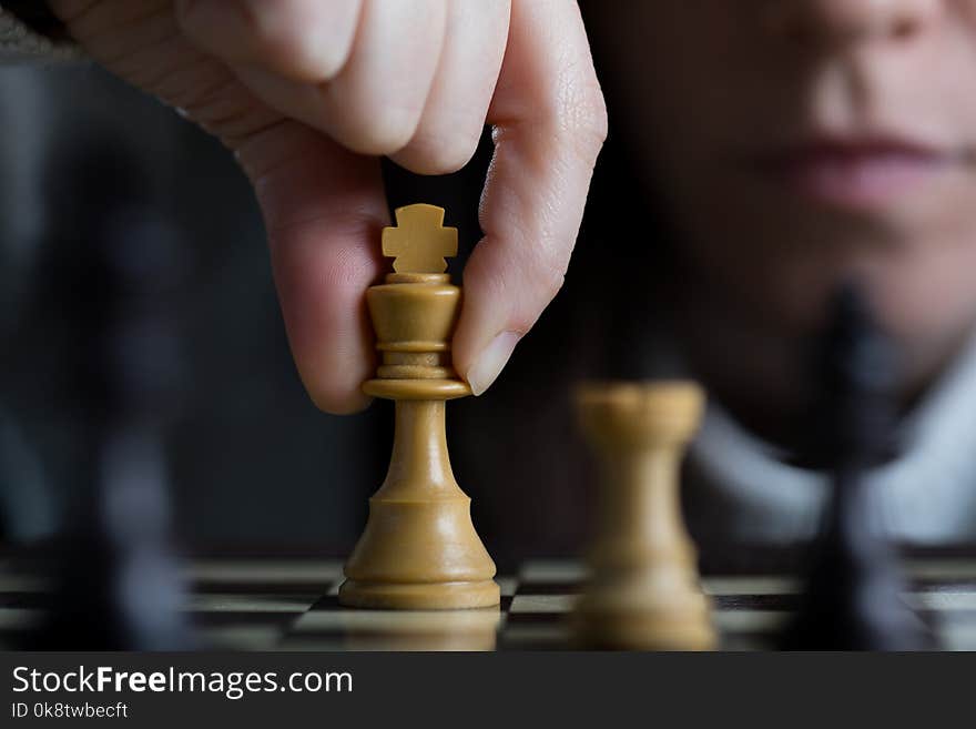 Detail of a Woman Playing Chess Moving the White King. Detail of a Woman Playing Chess Moving the White King