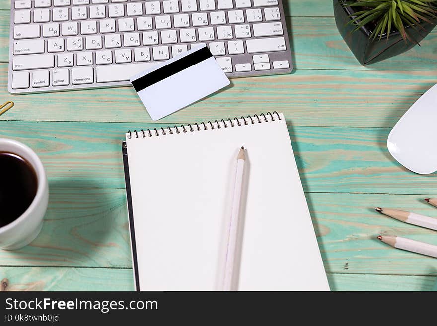 Office desk table with laptop, pen and notebook. Top view with copy space. Online shopping concept. Office desk table with laptop, pen and notebook. Top view with copy space. Online shopping concept.