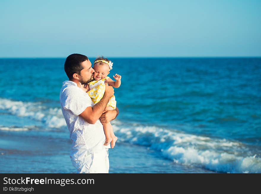 Happy father playing with cute little daughter at the beach. Rest in Turkey