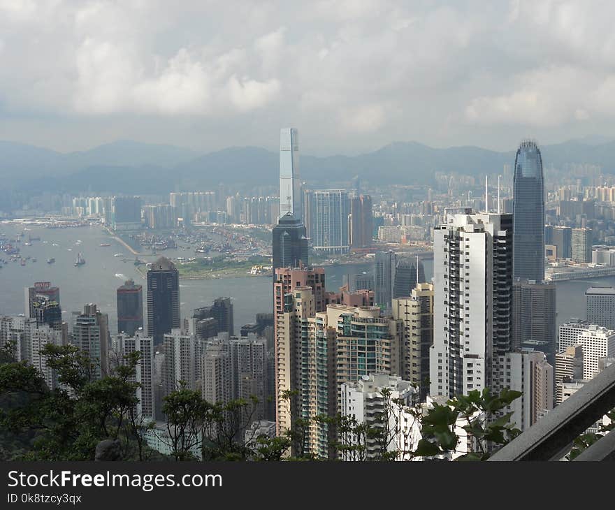 View of Hong Kong and its bay with ships and skyscrappers from a hill. View of Hong Kong and its bay with ships and skyscrappers from a hill