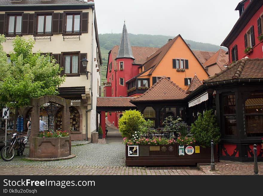 Photo from the central place of an old village in Alsace, France during a cloudy day