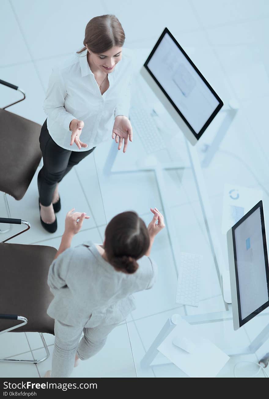 View from the top.two women colleagues discuss a work problem.