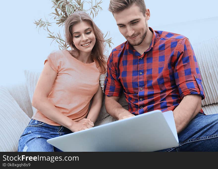 Happy modern couple surfing the net and working on laptop at home.photo with copy space