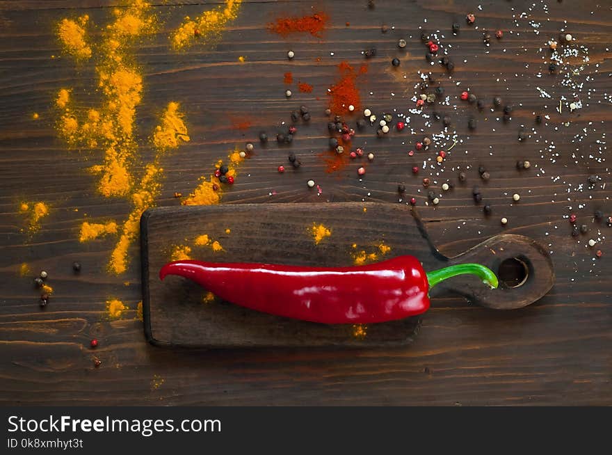 Red pepper on a dark background. Background with spices.spices. Top view. Close up. The concept of spices for cooking, Asian cuisine, copy space