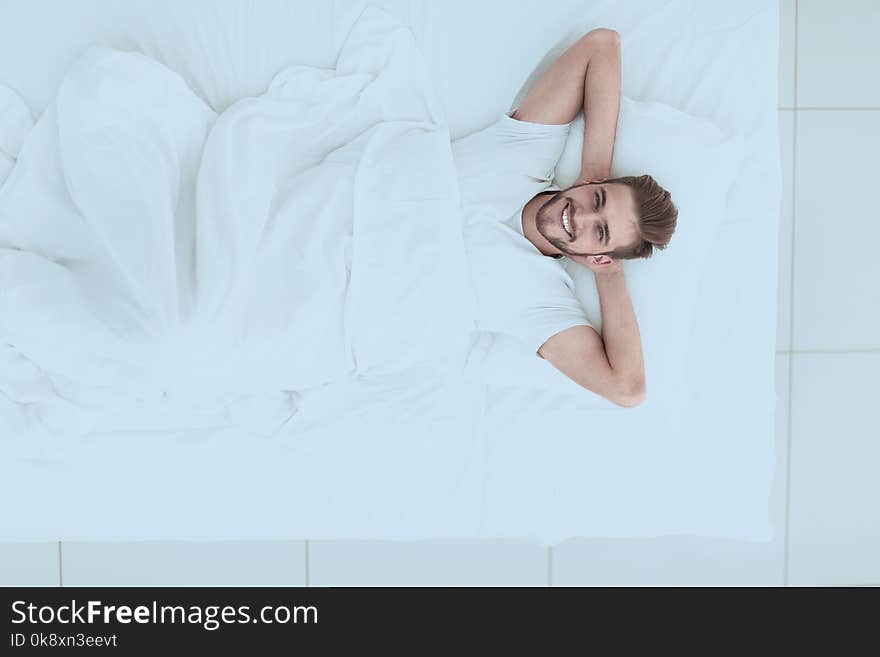 Top view.smiling man relaxing on the couch .photo with copy space