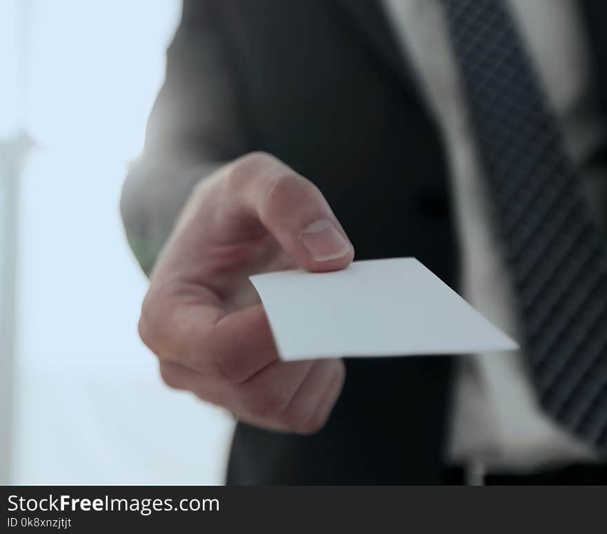 Business man giving business card on bright background