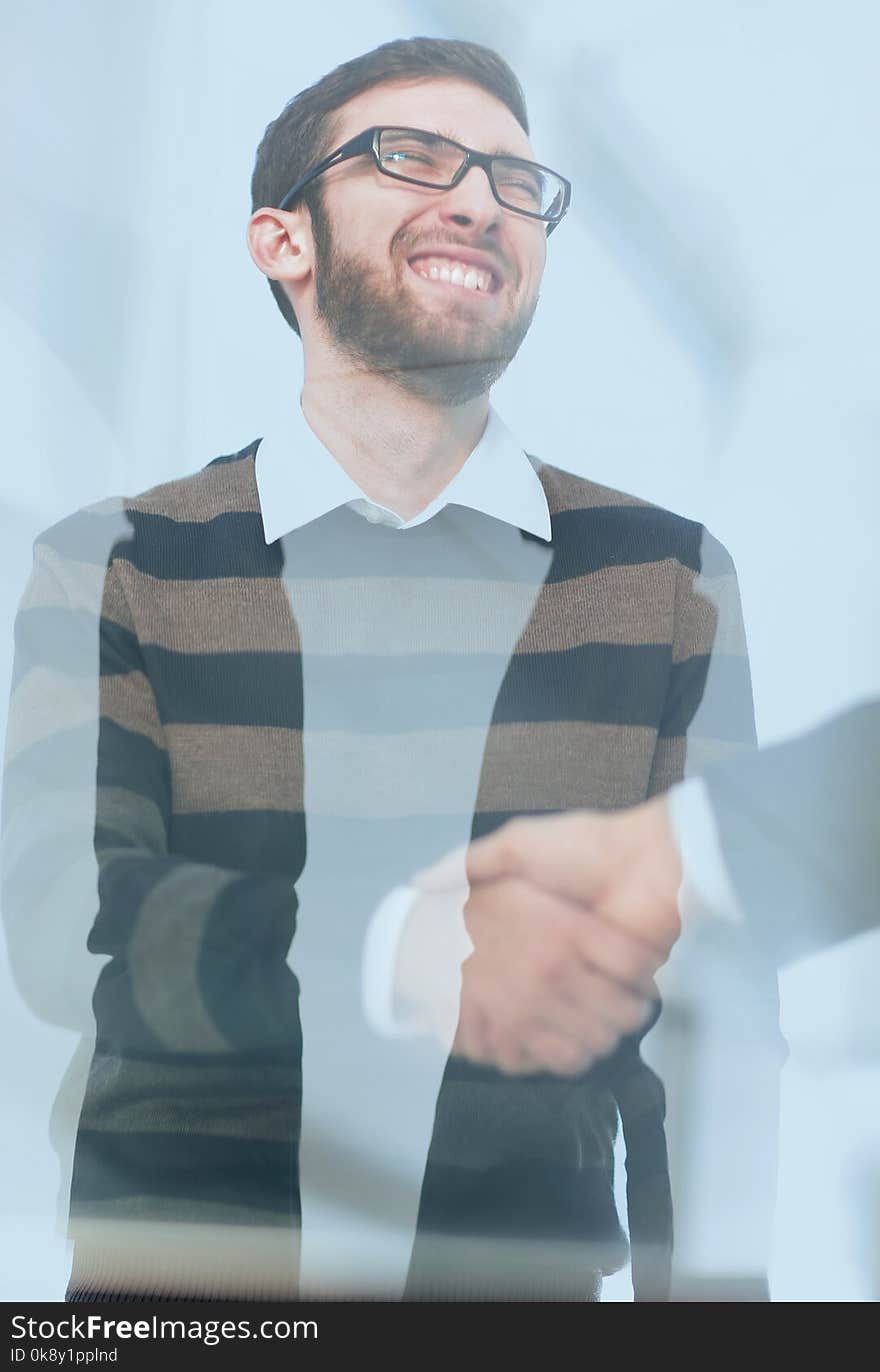 From behind the glass.handshake business people