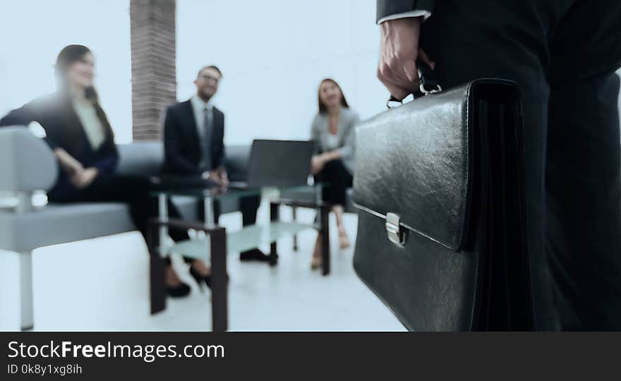 Close-up photo of hand of businessman with briefcase. Close-up photo of hand of businessman with briefcase.