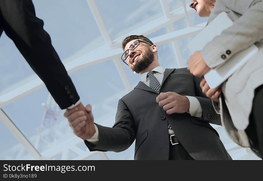 Close-up shot of businessmen shaking hands in the office. Close-up shot of businessmen shaking hands in the office