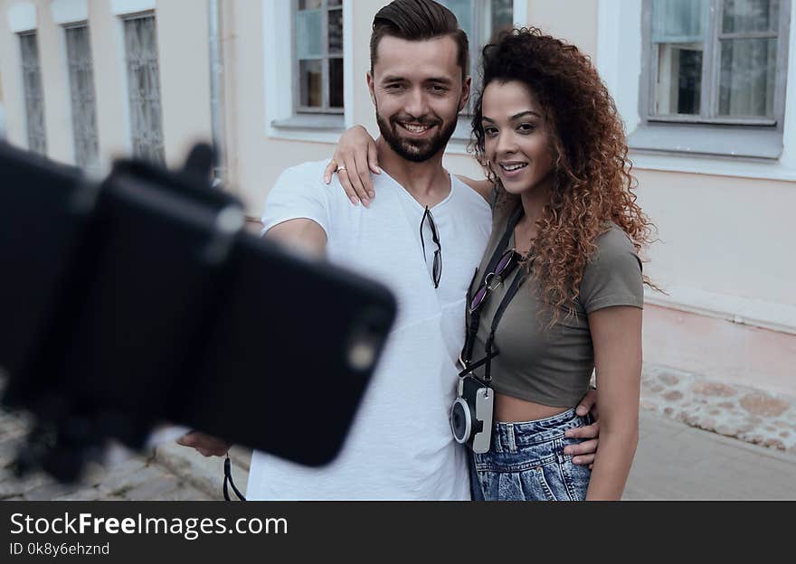 Happy young men and women taking self portrait . Happy young men and women taking self portrait .